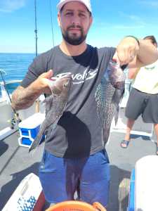 a person holding a fish in the water