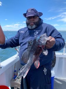 a man holding a fish in the water