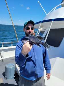 a man holding a fish in the water