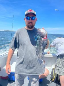 a man holding a fish in the water