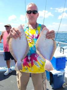 a man holding a fish