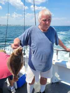 a man holding a fish in the water