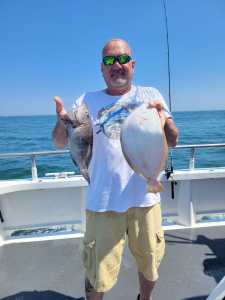 a person holding a fish in the water