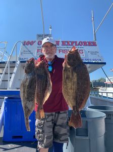 a man holding a fish on a boat