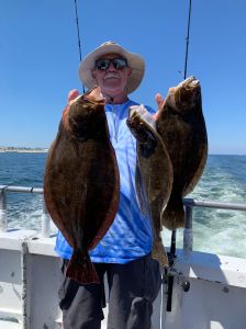 a man holding a fish in the water