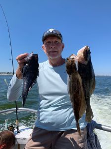 a man holding a fish in the water