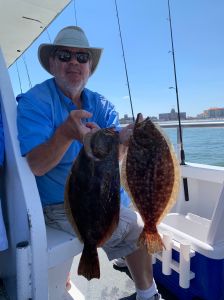 a man holding a fish on a boat