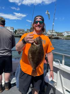 a man holding a fish in the water