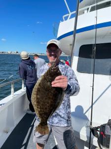 a person holding a fish on a boat