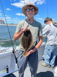 a person holding a fish on a boat