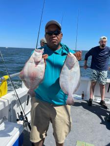 a person holding a fish on a boat