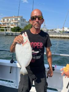 a man holding a fish in the water