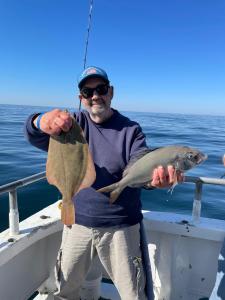 a person holding a fish on a boat