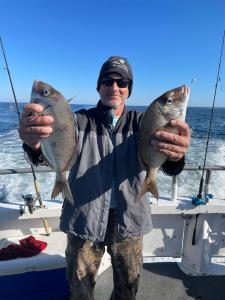 a man holding a fish in the water