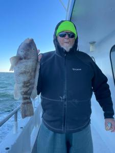 a man holding a fish in the water