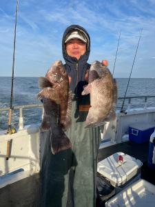 a person holding a fish on a boat