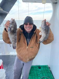 a person holding a fish on a boat