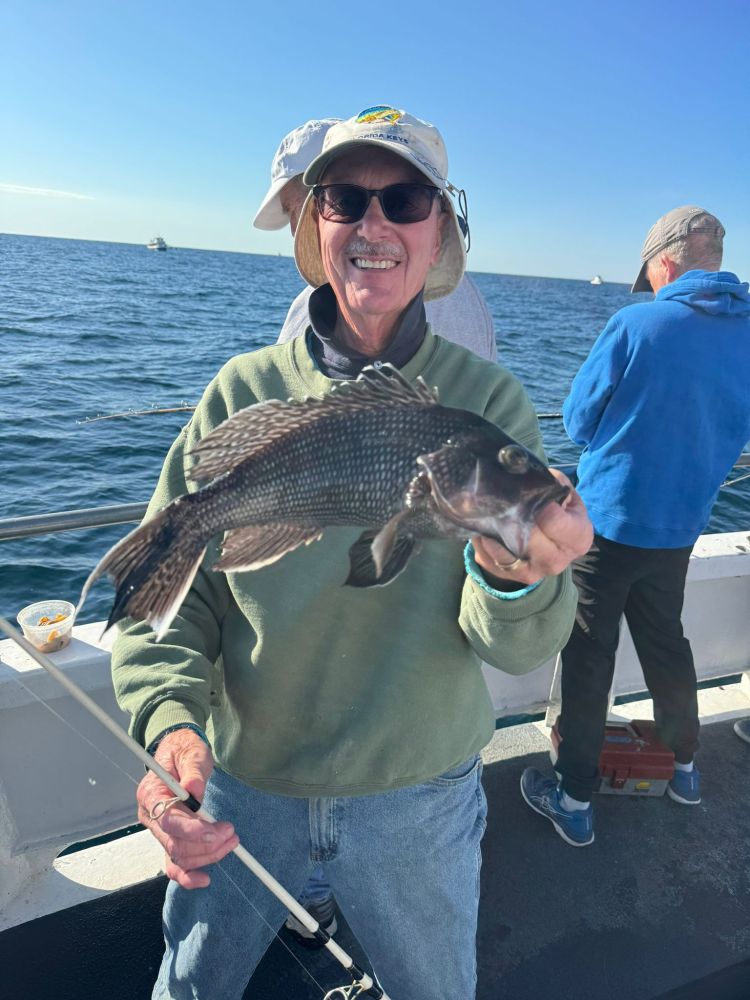 a person holding a fish in the water