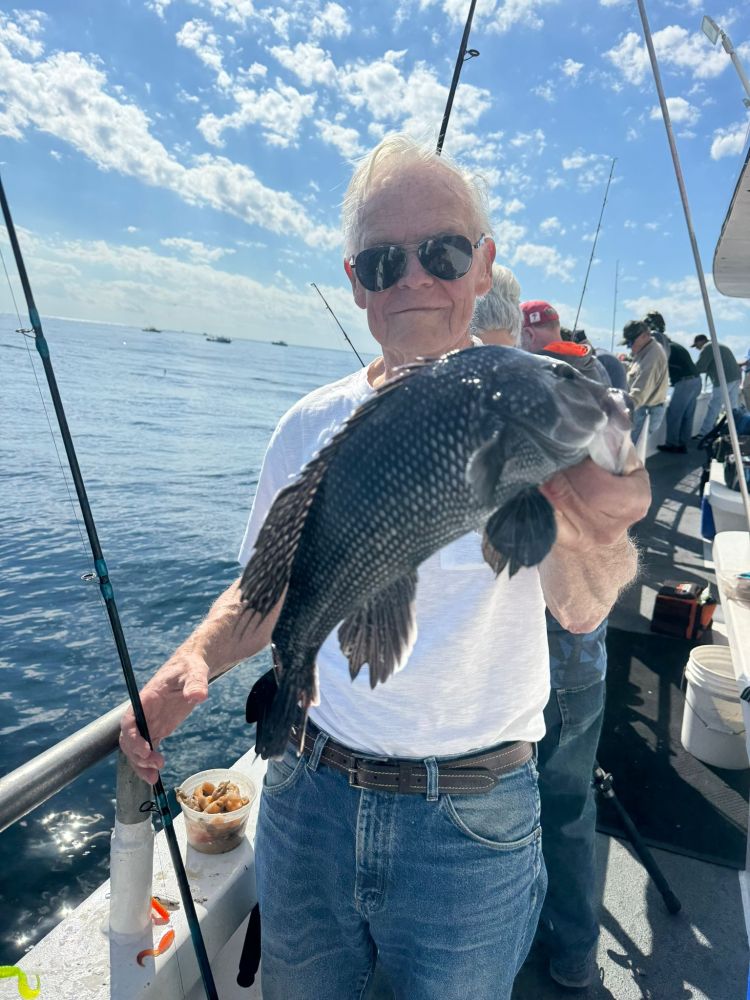 a man holding a fish in the water