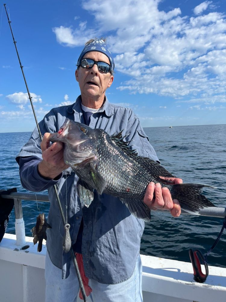 a man holding a fish in the water