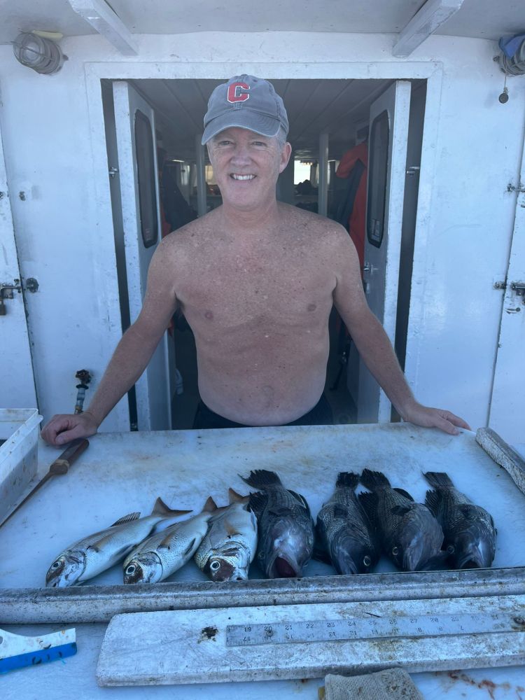 a man holding a fish