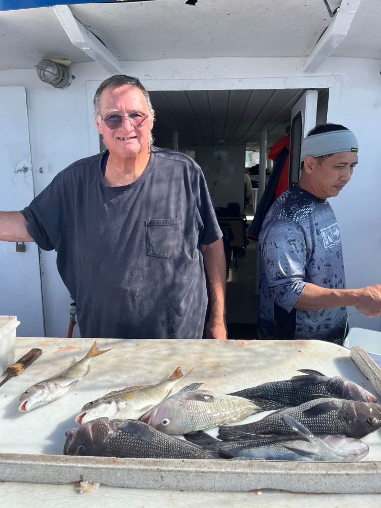 a man holding a fish