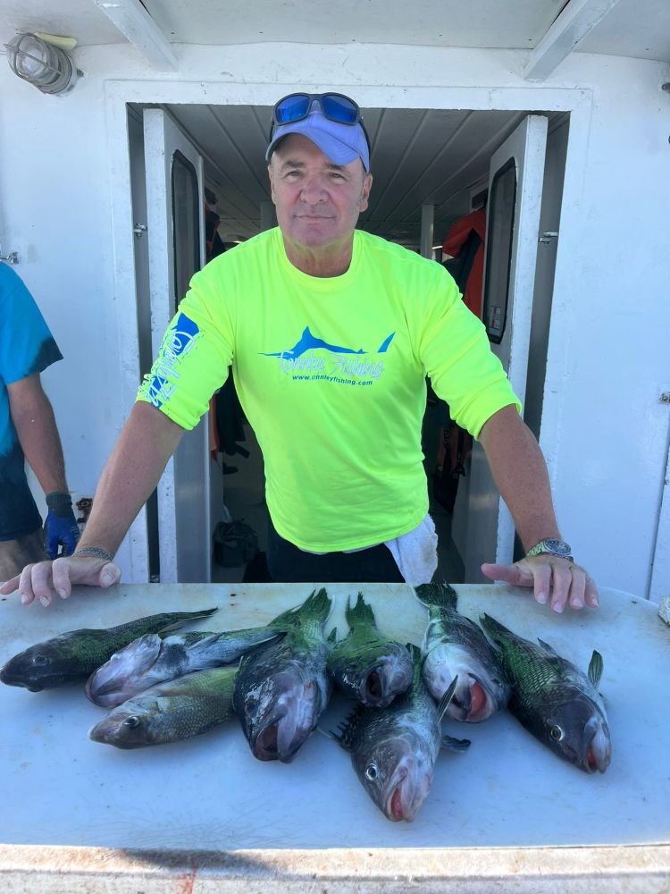 a man holding a fish